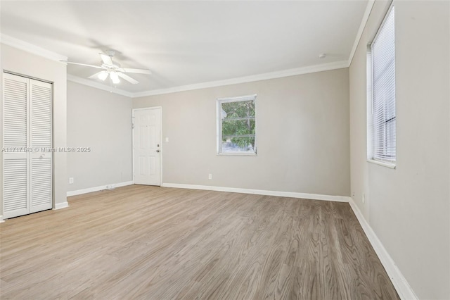 empty room featuring crown molding, ceiling fan, and light hardwood / wood-style flooring