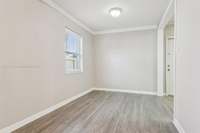 unfurnished room featuring ornamental molding and light hardwood / wood-style floors