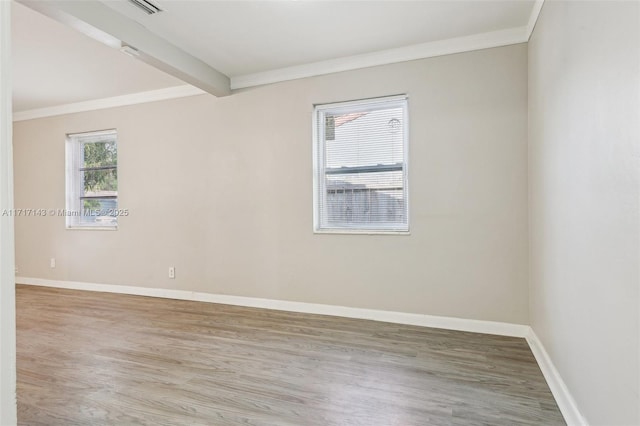 unfurnished room featuring beamed ceiling, wood-type flooring, and ornamental molding