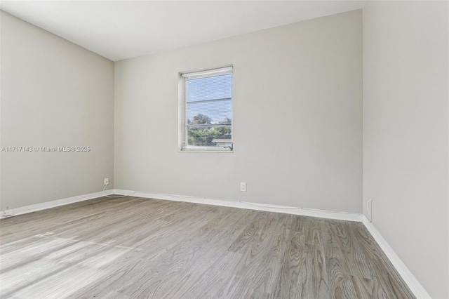 spare room with light hardwood / wood-style floors