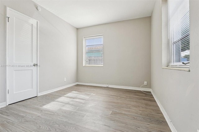 empty room with light hardwood / wood-style flooring