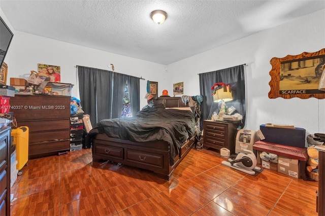 bedroom with hardwood / wood-style flooring and a textured ceiling