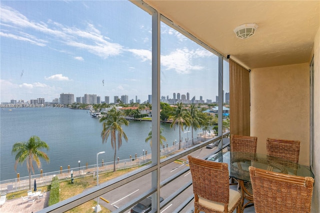 sunroom featuring a healthy amount of sunlight and a water view