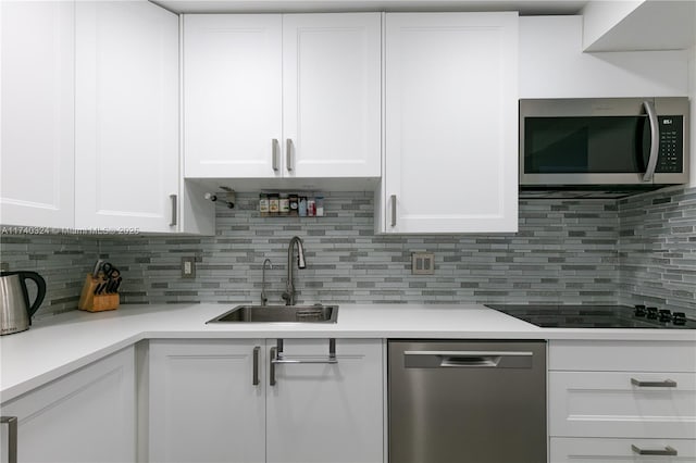 kitchen featuring sink, stainless steel appliances, and white cabinets