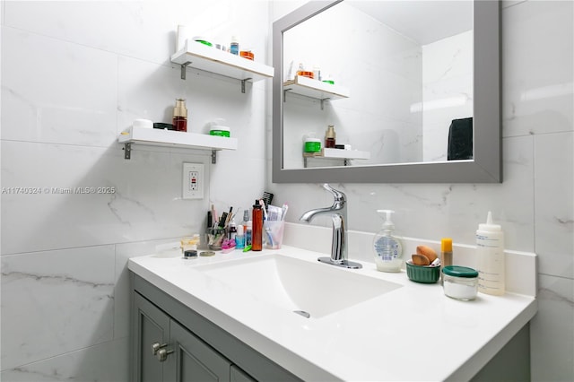 bathroom featuring vanity and tile walls