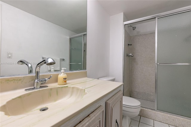 bathroom featuring walk in shower, vanity, toilet, and tile patterned flooring