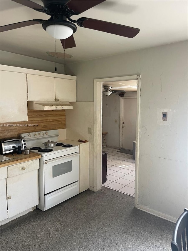 kitchen featuring electric stove, ceiling fan, and white cabinets