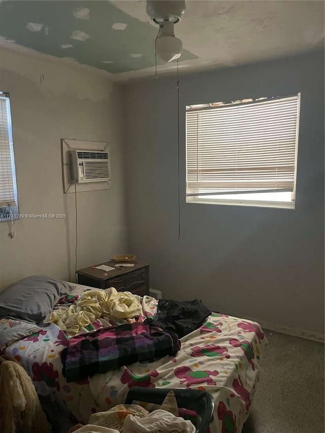 carpeted bedroom featuring an AC wall unit