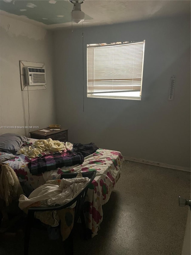 bedroom with ceiling fan and a wall unit AC