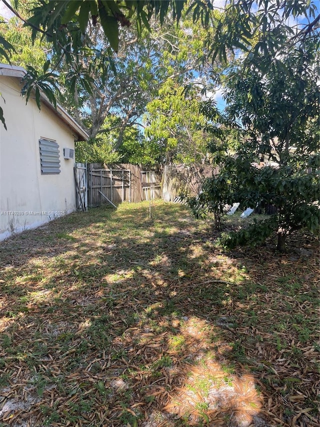 view of yard with an AC wall unit