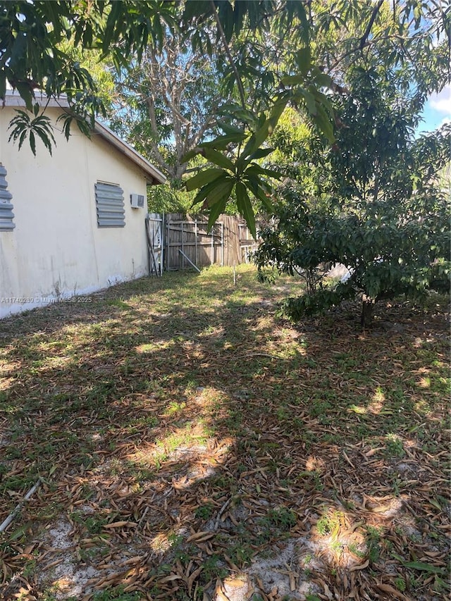 view of yard featuring an AC wall unit