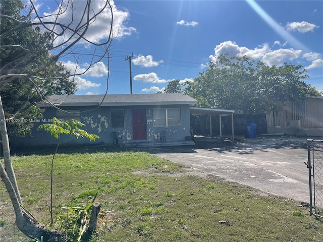 view of front of home featuring a front lawn and a carport