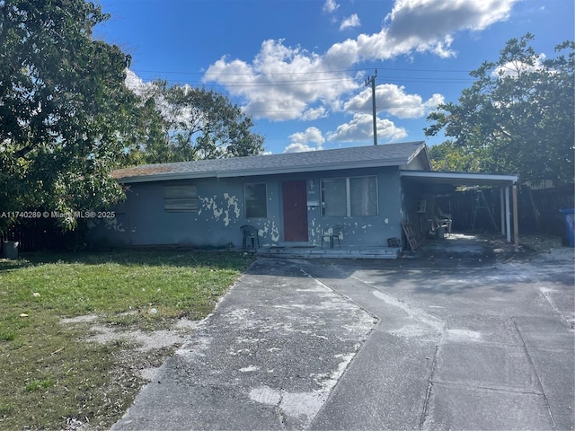 view of front facade with a carport and a front lawn