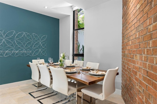 dining space with brick wall