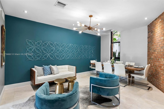 living room featuring brick wall, light tile patterned floors, and a notable chandelier