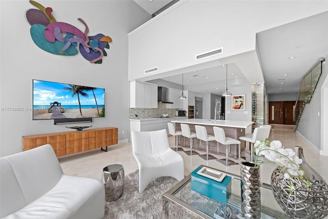 living room with a high ceiling and sink