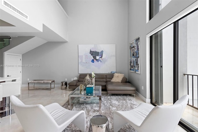 living room featuring a towering ceiling