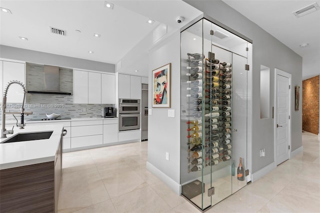 wine cellar featuring sink and light tile patterned floors