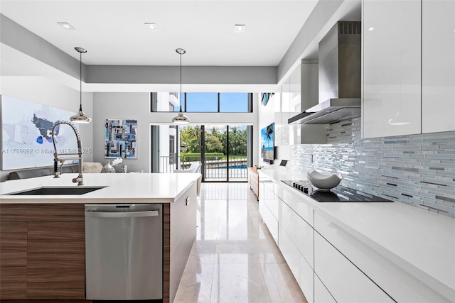 kitchen featuring wall chimney range hood, sink, white cabinets, and dishwasher