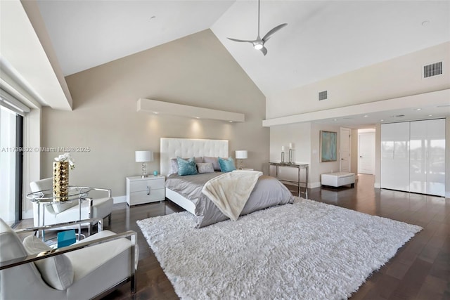 bedroom featuring ceiling fan, dark wood-type flooring, and high vaulted ceiling