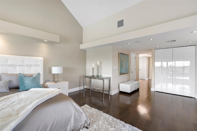 bedroom featuring dark hardwood / wood-style floors and high vaulted ceiling