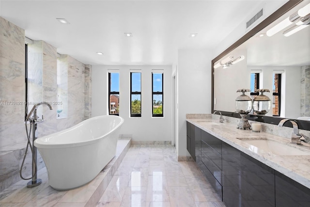 bathroom with vanity and a bathtub