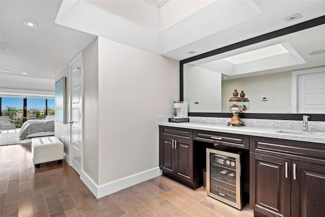 bathroom featuring vanity, beverage cooler, and hardwood / wood-style floors