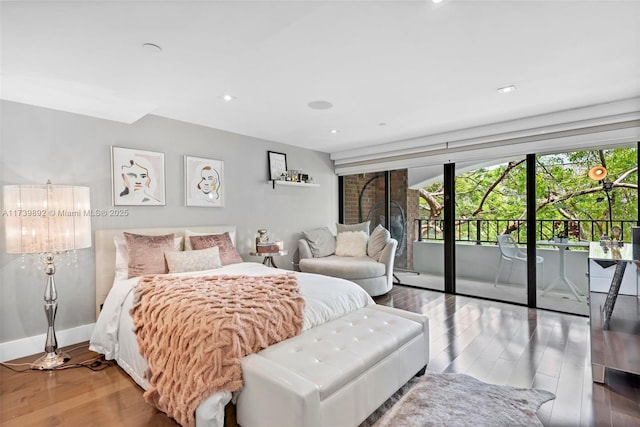 bedroom featuring access to exterior and wood-type flooring