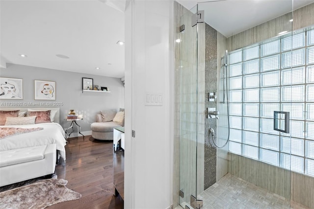 bathroom featuring wood-type flooring and walk in shower