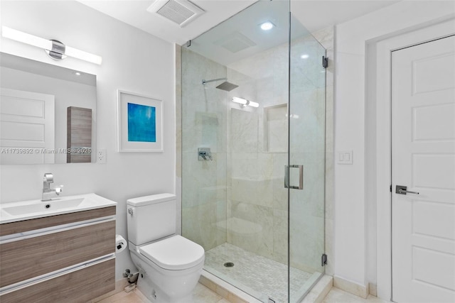 bathroom with walk in shower, vanity, and toilet