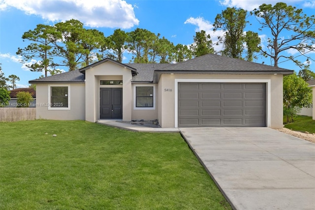 ranch-style house featuring a garage and a front lawn