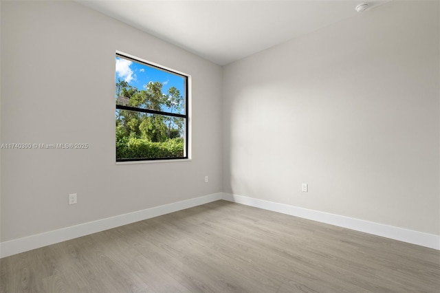 empty room with light hardwood / wood-style flooring