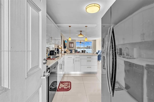 kitchen with decorative light fixtures, black dishwasher, sink, white cabinets, and kitchen peninsula