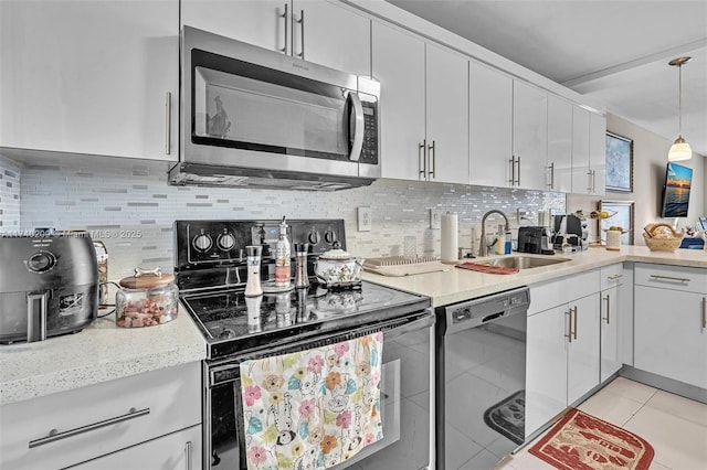 kitchen featuring sink, white cabinets, decorative backsplash, hanging light fixtures, and black appliances