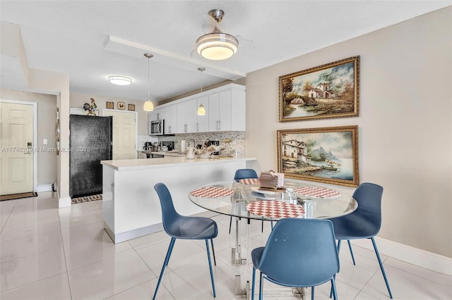 dining space with light tile patterned floors, sink, and a textured ceiling