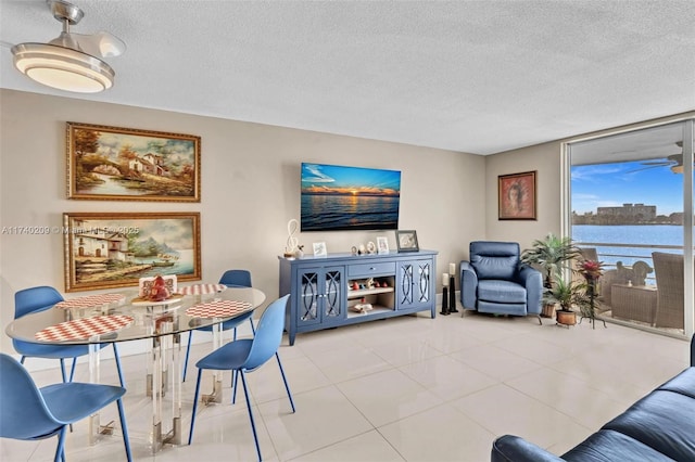 living room with a textured ceiling and light tile patterned floors