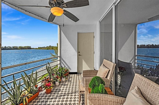 balcony featuring a water view and ceiling fan