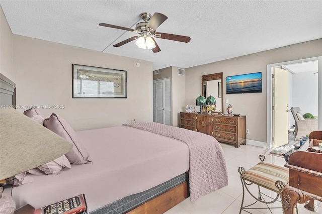 bedroom with light tile patterned floors, a closet, a textured ceiling, and ceiling fan