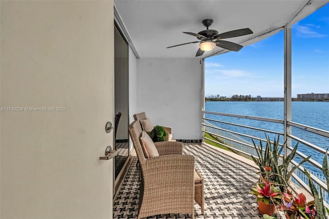 balcony with a water view and ceiling fan