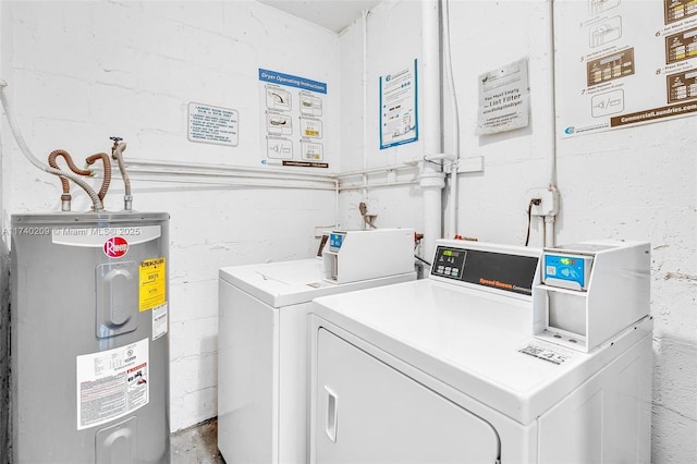 clothes washing area featuring washer and dryer and water heater