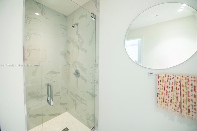 bathroom featuring a marble finish shower