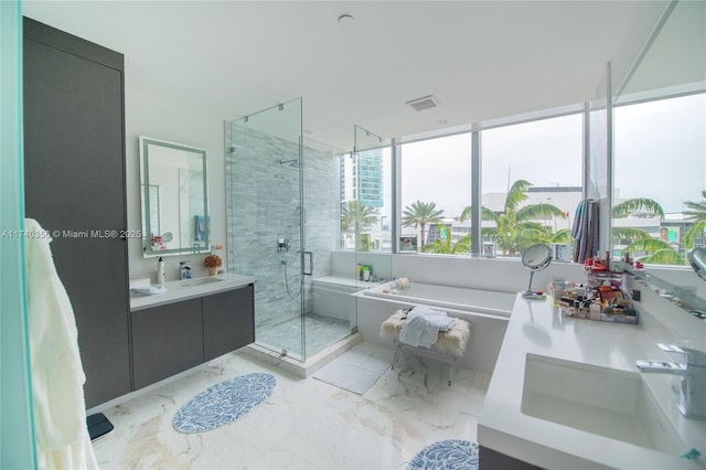 full bathroom featuring visible vents, marble finish floor, a stall shower, and a garden tub