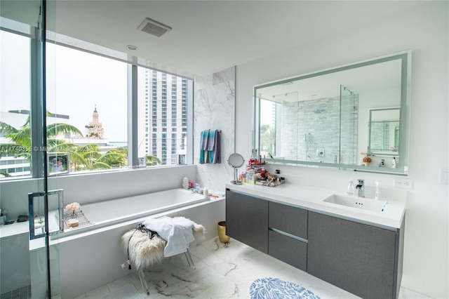 full bath featuring visible vents, a garden tub, marble finish floor, a shower stall, and vanity