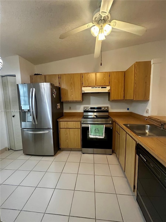 kitchen featuring sink, light tile patterned floors, ceiling fan, appliances with stainless steel finishes, and a textured ceiling