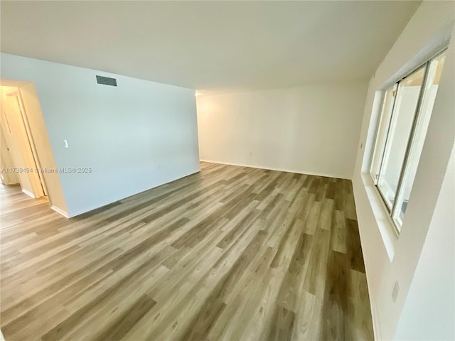 unfurnished room with light hardwood / wood-style floors