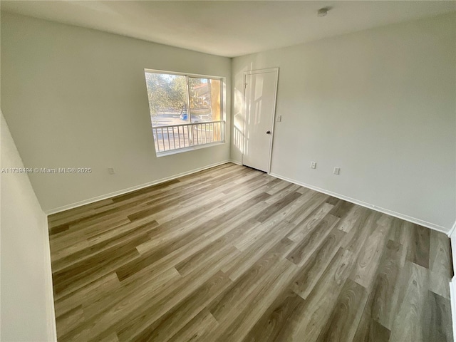 unfurnished room with light wood-type flooring