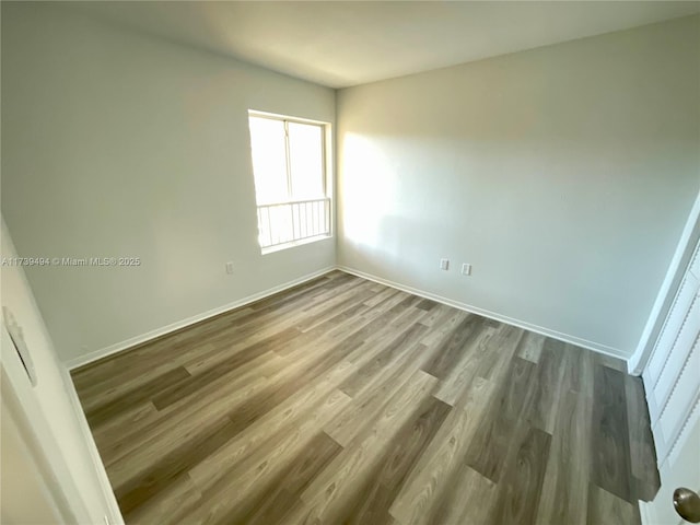 spare room with hardwood / wood-style floors