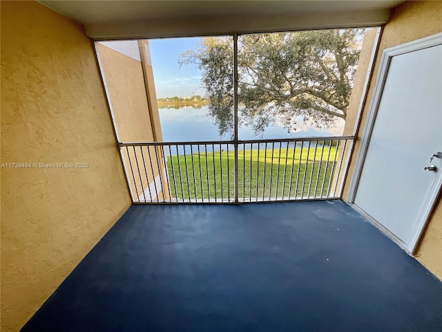 unfurnished sunroom with a water view