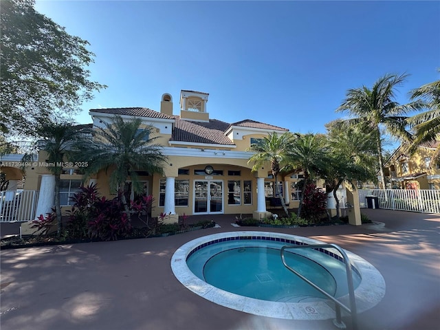 view of swimming pool with an in ground hot tub