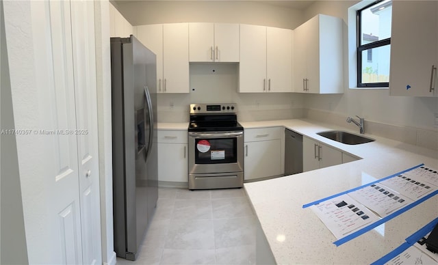 257 SW 159th Ct Unit 0, Pembroke Pines, FL 33027 - kitchen with appliances with stainless steel finishes, a sink, light tile patterned floors, and a peninsula